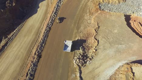 Heavy-machinery-working-in-te-riotinto-open-pit-copper-mine-aerial-shot