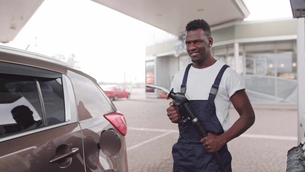 Man refueling a car at a gas station