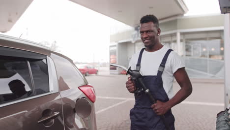 man refueling a car at a gas station