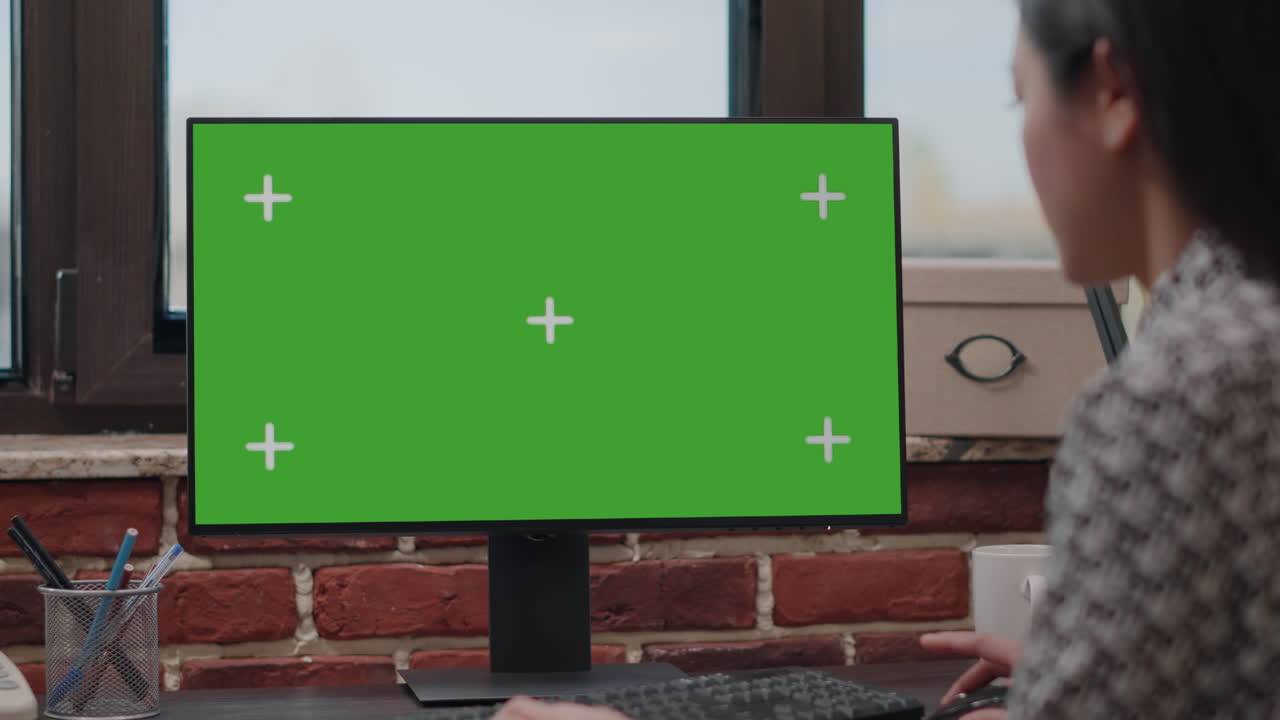 Close up of worker using computer with horizontal green screen