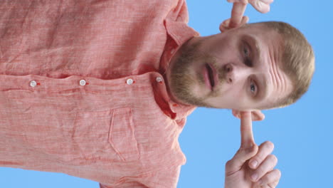 man covering ears with hands