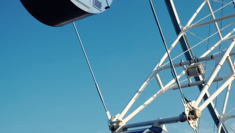 blue ferris wheel turning on a sunny day