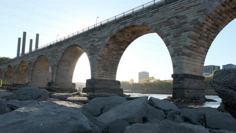 stone arch bridge backlit on bright sunny morning