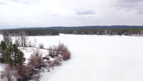 drone aerial of the winter showing the vacation homes around island park reservoir in island park idaho cabins on the side of the lake