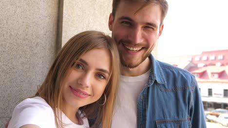 happy couple taking selfie outdoors