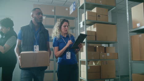 warehouse workers inspecting and handling packages