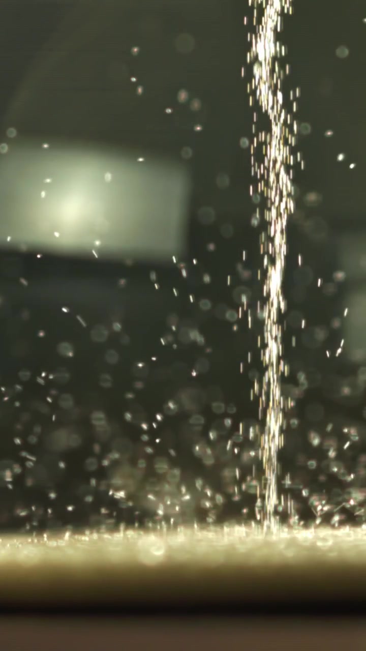 Flusso astratto di particelle scintillanti che cadono