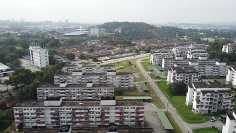 slow pan tilt down establishing shot of low density buildings in malaysia at midday