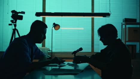 medium silhouette video of a offender perpetrator or prisoner sitting in the room the detective medium silhouette video of a offender perpetrator or prisoner sitting in the room the detective brings him a cup of water and begins the interrogation process true crime documentary creative