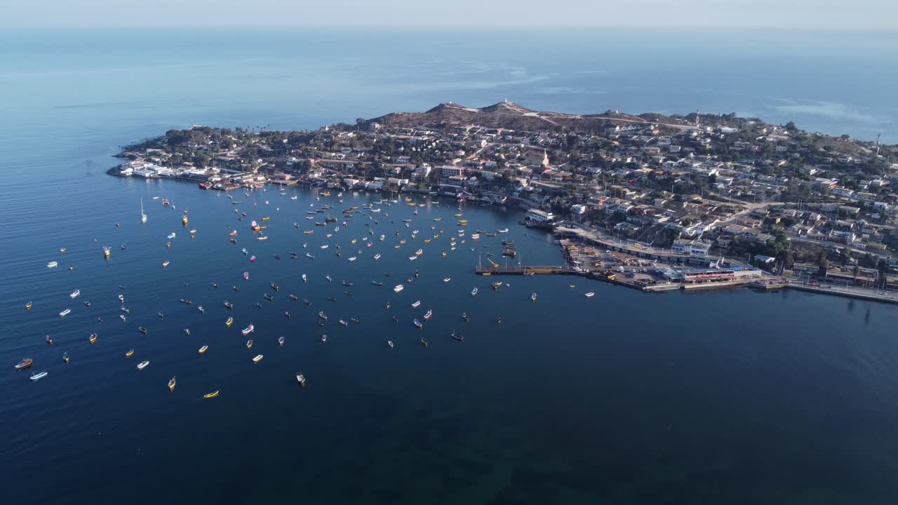 Aerial: Coastal headland village of Tongoy Chile with fishing harbor