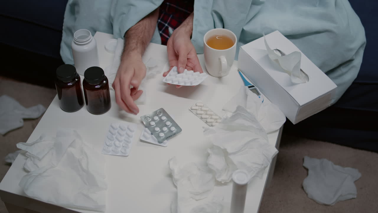Top view of table with medicaments, bottles of pills and tea