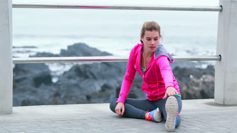 pretty young determined woman stretching