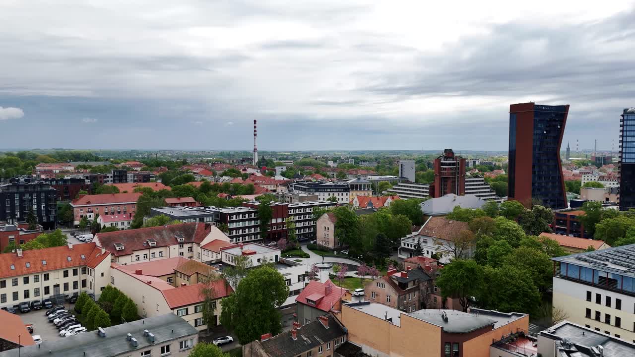 Aerial of Klaipeda city skyline apartment buildings under the rainy sky
