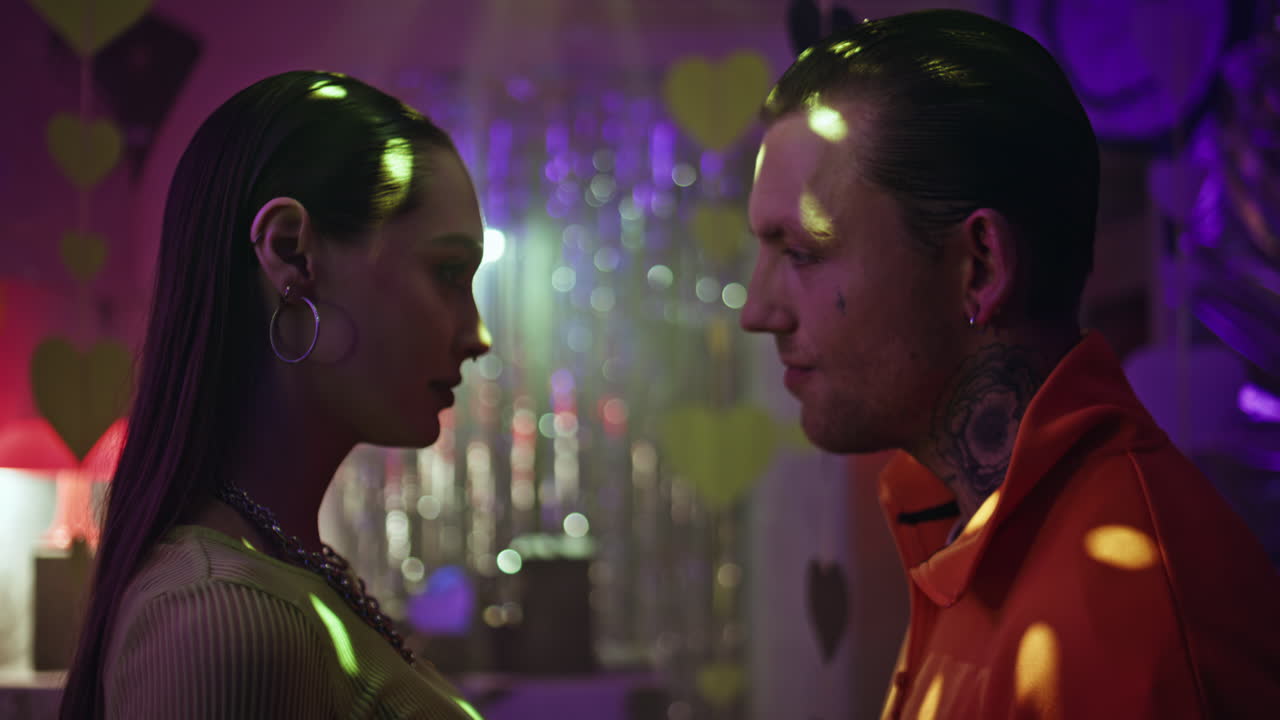 Flirting people standing party atmosphere closeup. Romantic tattooed man looking