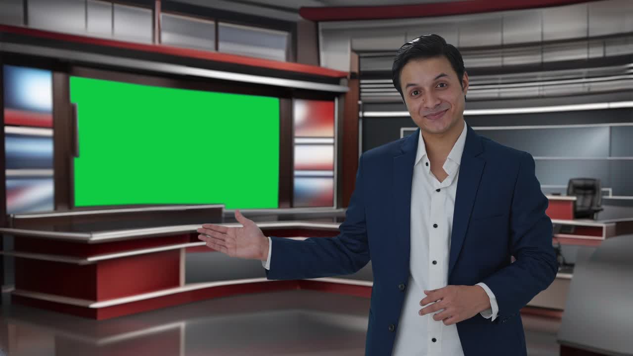 Happy Indian journalist pointing to Copy Space and showing victory sign