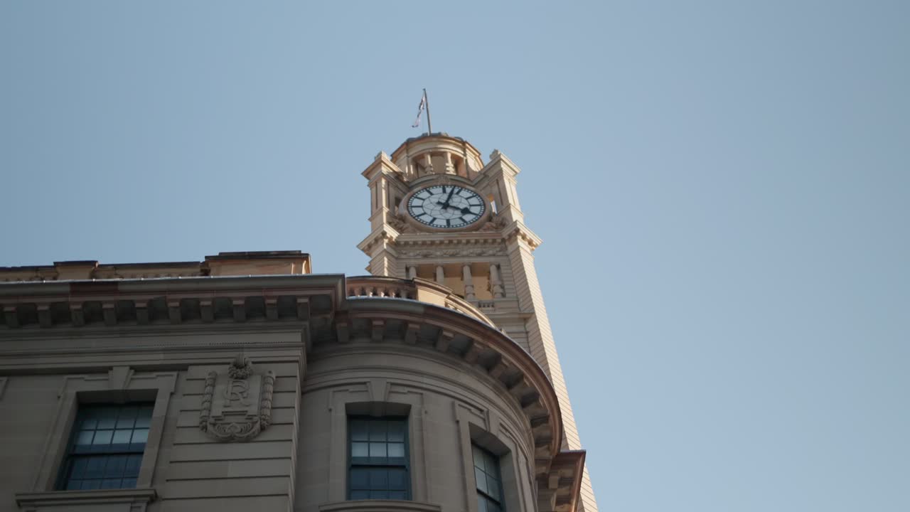 Slow motion shot of the clock tower at Central Station in Sydney, lit by the afternoon sun
