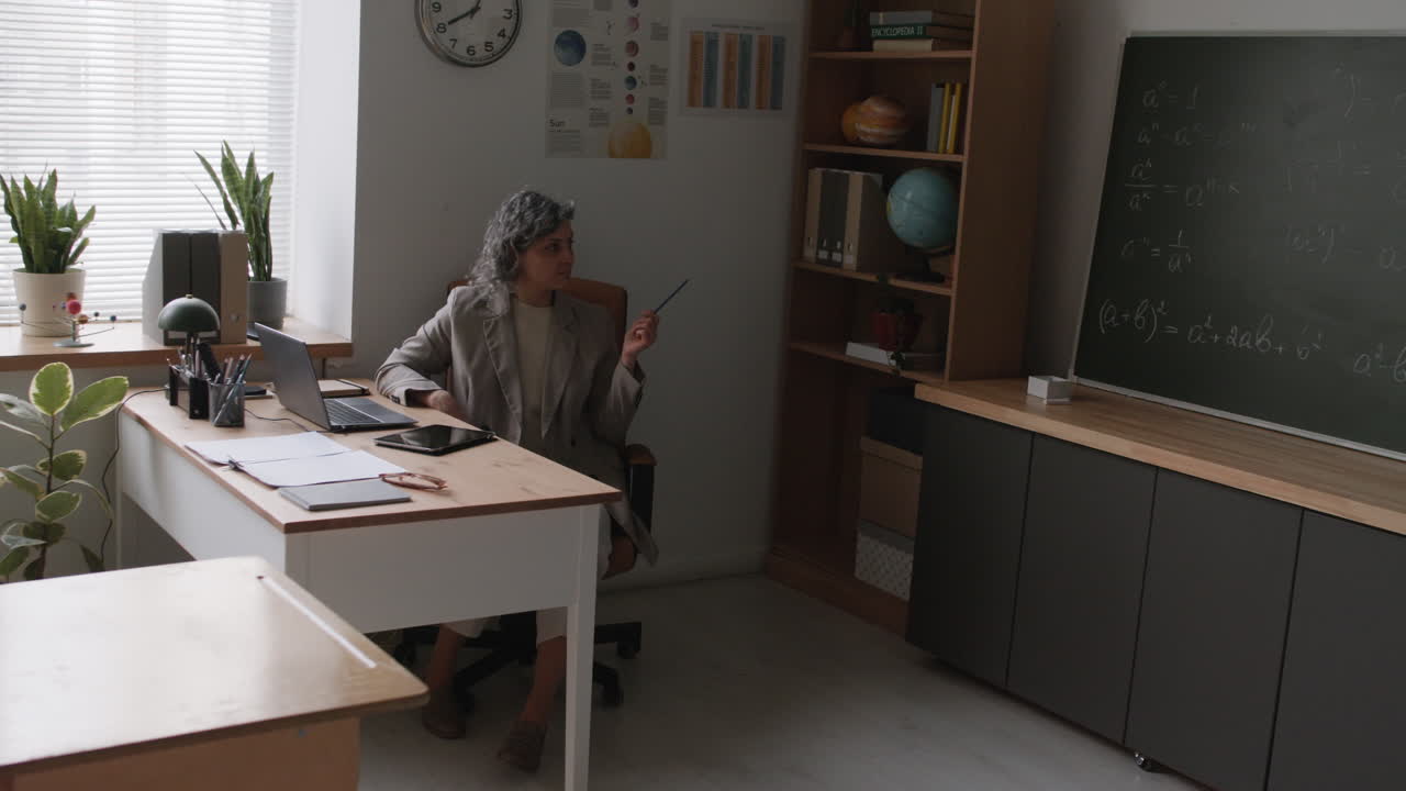 Teacher giving online lesson in classroom