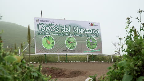 Handheld-shot-of-a-signage-introducing-Lomas-de-Manzano,-Pachacamac,-Lima,-Peru