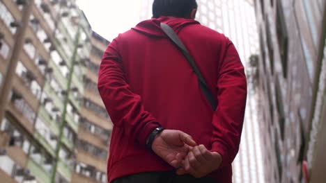 man walking among tall buildings