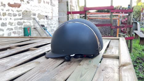 female jockey picking up her helmet