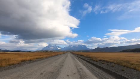 a long dirt road to torres del paine in chilean patagonia