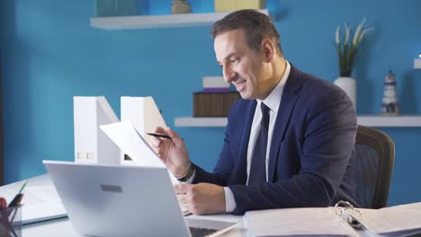 businessman analyzing positive and profitable data rejoices and smiles.