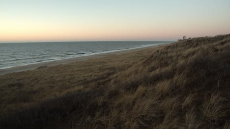 dunes with the sea and the beach in the background after the sunset on sylt