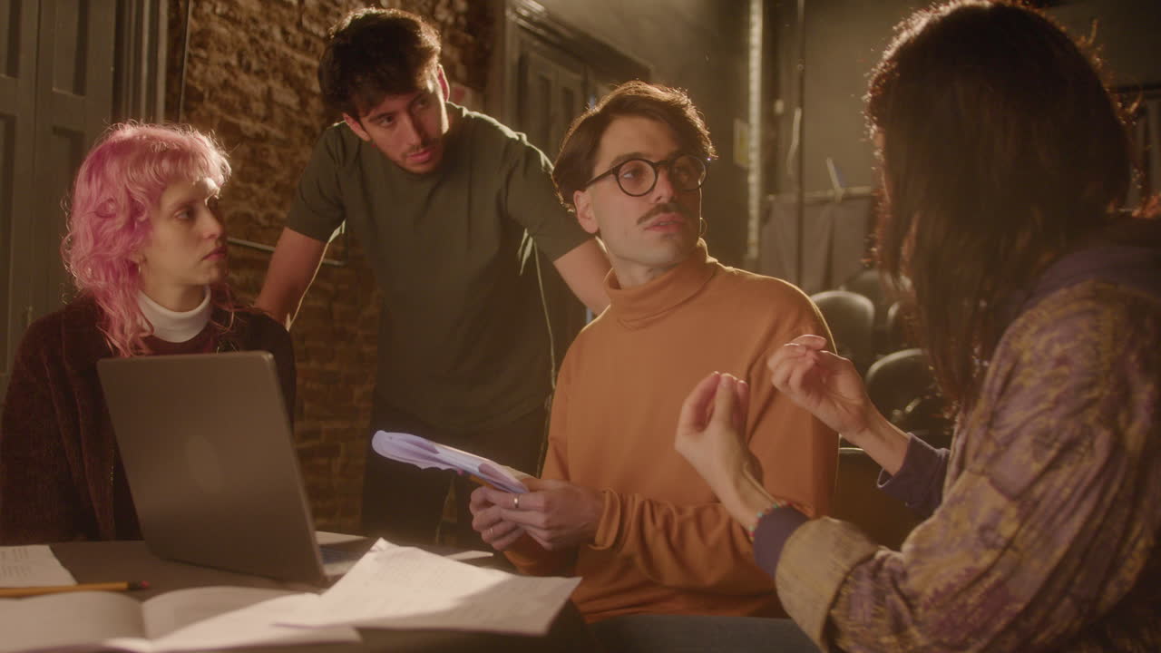 Actors and Director Working with Laptop and Papers on Theater Stage
