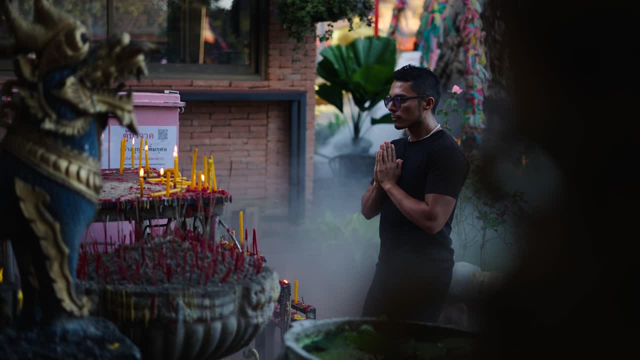 Man Praying at a Temple in Thailand