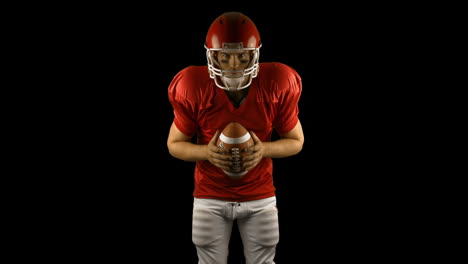 red american football player holding a ball