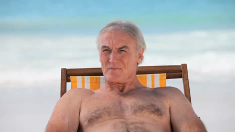 un anciano sonriente mirando el horizonte.