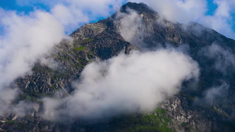 Heavy-clouds-whirl-above-the-forest-covered-mountains-and-bare-peaks