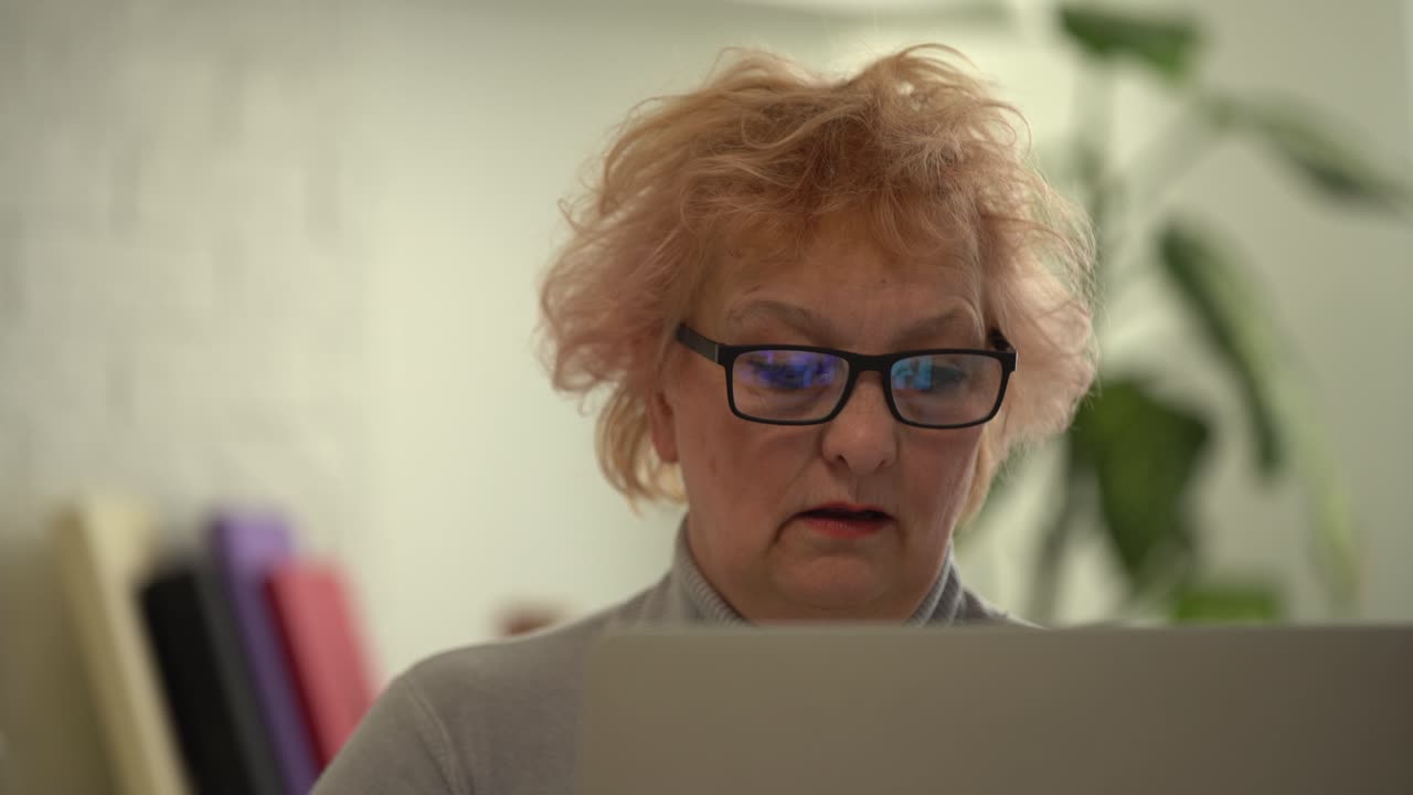 Video call. Good-looking elderly lady i having a video call on laptop