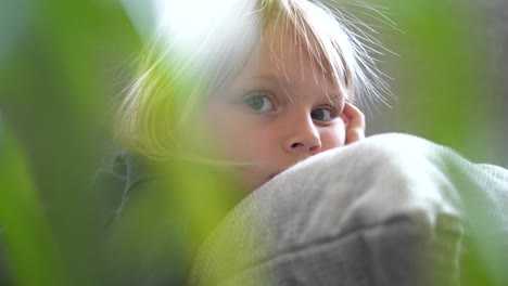 Blonde-young-girl-gazes-at-camera,-slow-motion-slider-shot