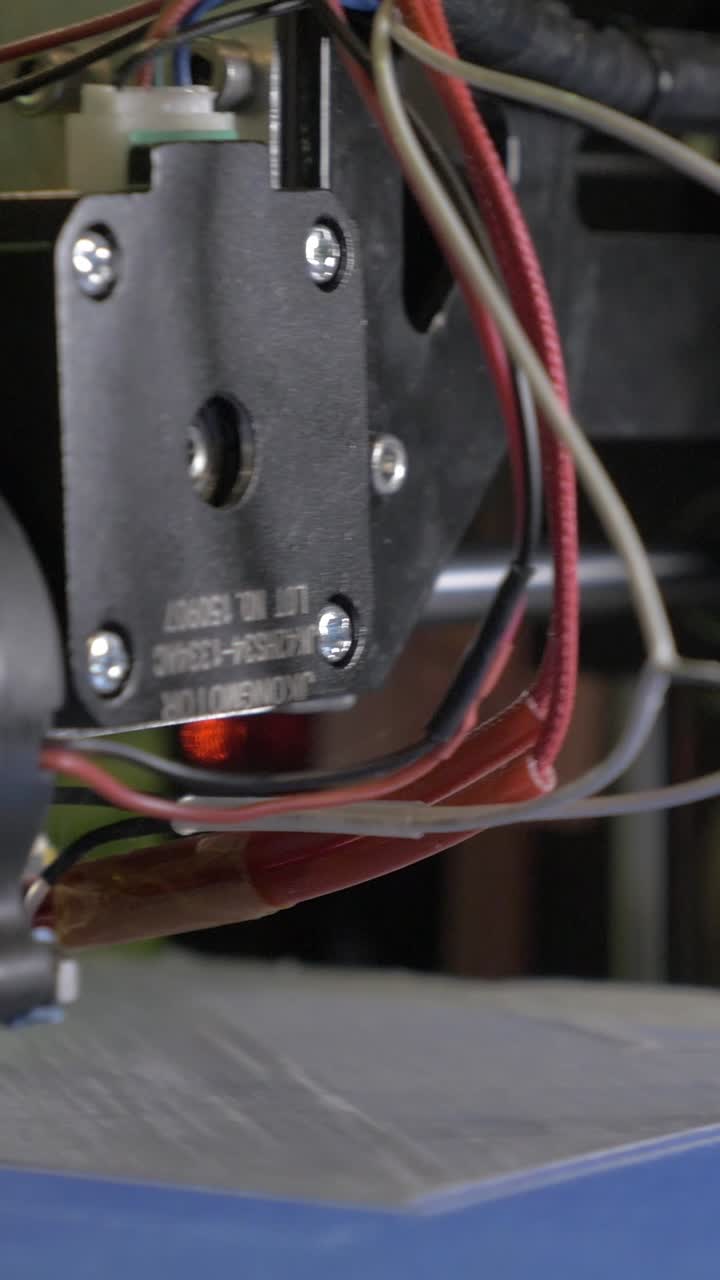 Close-up of 3D Printer Nozzle Extruding Plastic Filament