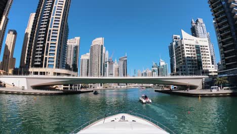 view front of yacht at dubai marina between skyscrapers