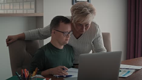 Caucasian-man-with-down-syndrome-learning-with-his-mum-at-home.