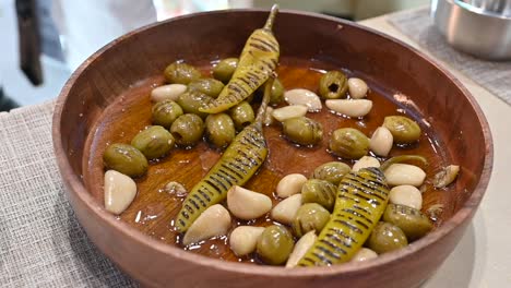 grilled green olive, garlic and green chilli pickles are displayed during the gulf food exhibition 2023