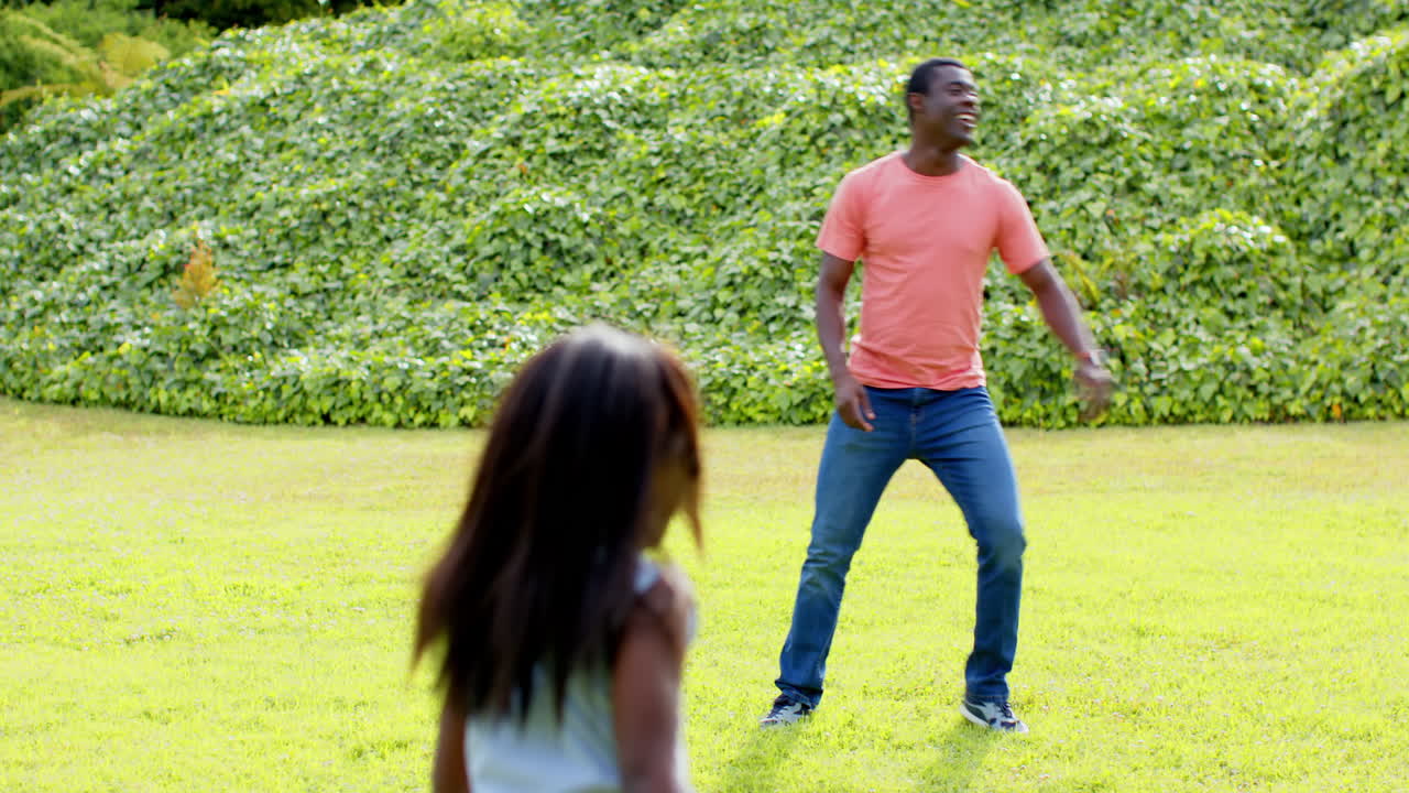 African American, Father playing frisbee in park, enjoying outdoor fun and laughter, copy space