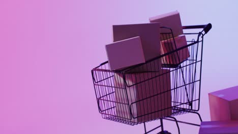 Video-of-boxes-and-shopping-trolley-with-copy-space-over-neon-purple-background