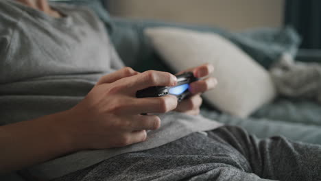 teenager playing video games on a couch