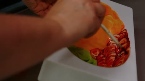 Worker-painting-a-chocolate-mould-using-colored-chocolate