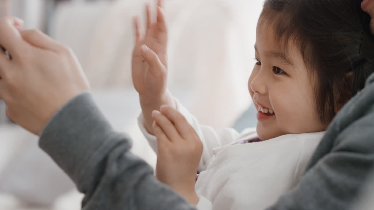 asian father and child using smartphone having video chat little girl waving sharing weekend with with dad enjoying chatting on mobile phone to friend 4k
