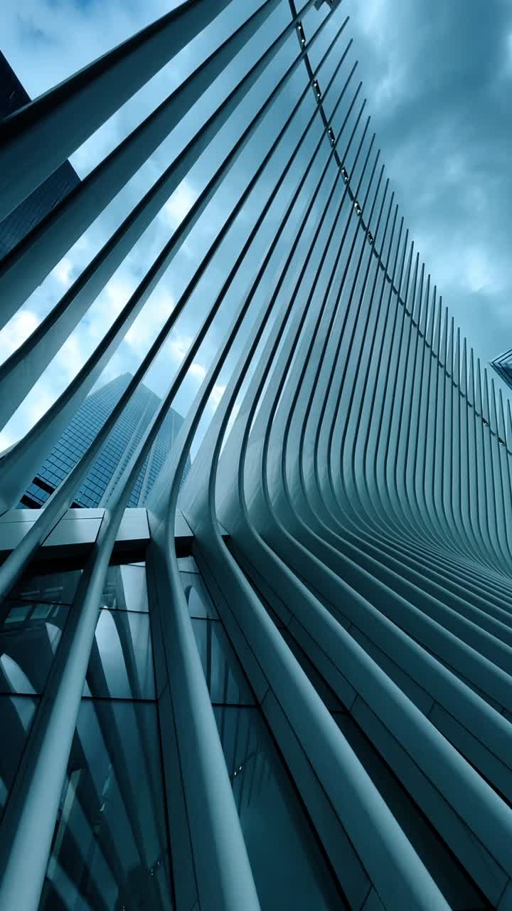 Low angle view of Oculus building architecture at World Trade Center. Abstract perspective of white steel ribs of the Oculus structure against cloudy sky in New York City