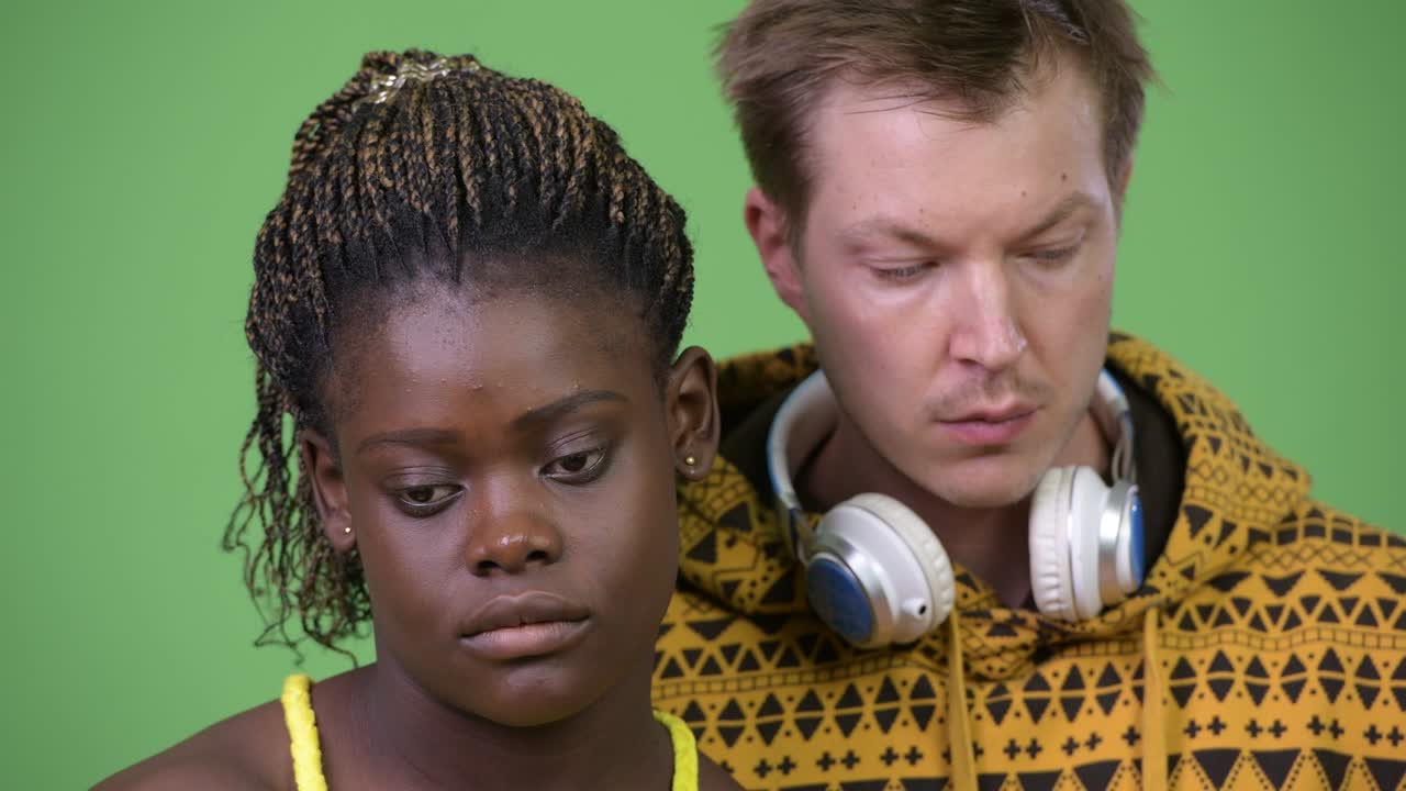 Young multi-ethnic couple looking down together