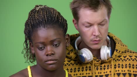 young multi-ethnic couple looking down together