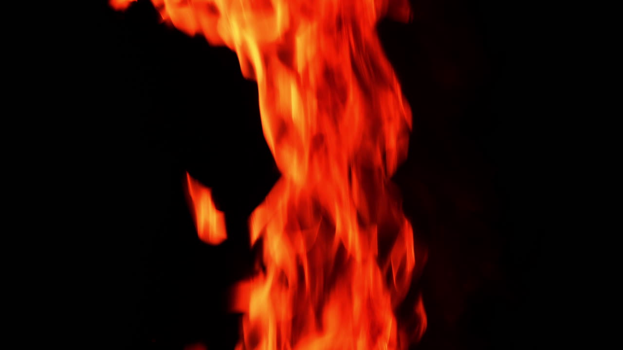 Beautiful fire flame going up. Burning flame isolated on the black backdrop.