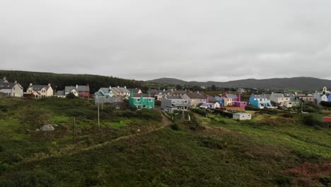 a drone recording of a typical traditional colourful irish village, eyeries, ireland