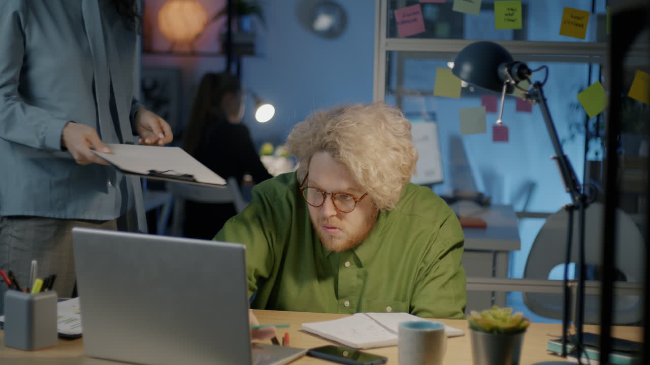 Employee Working Late at Night in Office