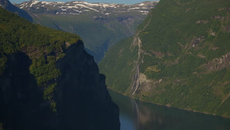 camera zooms into the mountainside and the waterfall seven sister in geirangerfjord, norway